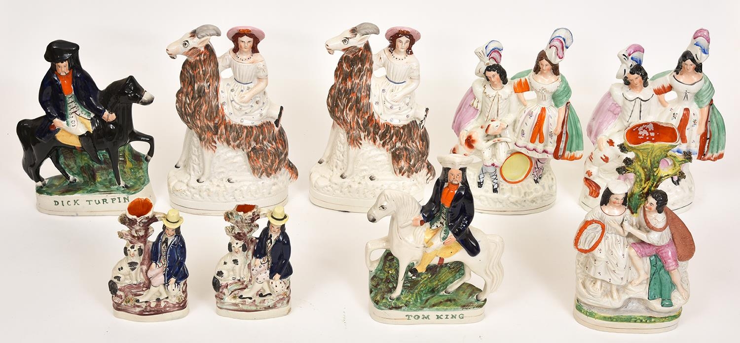 A pair of Staffordshire flatback figures of girls riding goats, three others and a spill holder