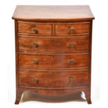 An early Victorian bow fronted mahogany commode chest, with hinged front and dummy drawers, 71cm