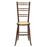 An early Victorian stained beech child's correction chair, with caned seat, seat height 49cm