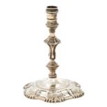 A George II silver taperstick, with banded sconce, knopped stem and moulded foot with six shells,