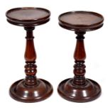 Two similar early Victorian turned mahogany candle stands, c1840, 27 and 28cm h Both in good