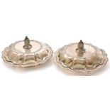 A pair of George IV silver entrée dishes and covers, of lobed and fluted round design with gadrooned