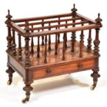 A Victorian mahogany Canterbury, c1850, with turned finials and slender balusters, fitted with a