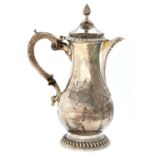 A George III silver jug, of baluster shape with ogee lid, beaded lip and gadrooned rims, engraved