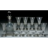 An English glass decanter, 19th c, of fluted and faceted club shape with three neck rings and a