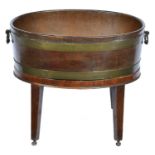 A George III brass bound oval mahogany wine cooler, c1810,  with hinged brass loop handles, copper