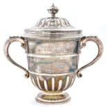 Racing Trophy. A George V silver cup and cover, of urnular form, with ogee domed cover and leaf