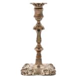 A William IV silver candlestick, with shell cornered nozzle and foot, waisted sconce and knopped