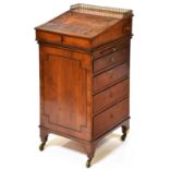 A Regency yew wood davenport, c1810, the sliding top with brass gallery and tooled leather inlet