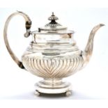 A George IV silver teapot, spirally reeded, crested, 21cm h, by John Edward Terrey, London 1821,