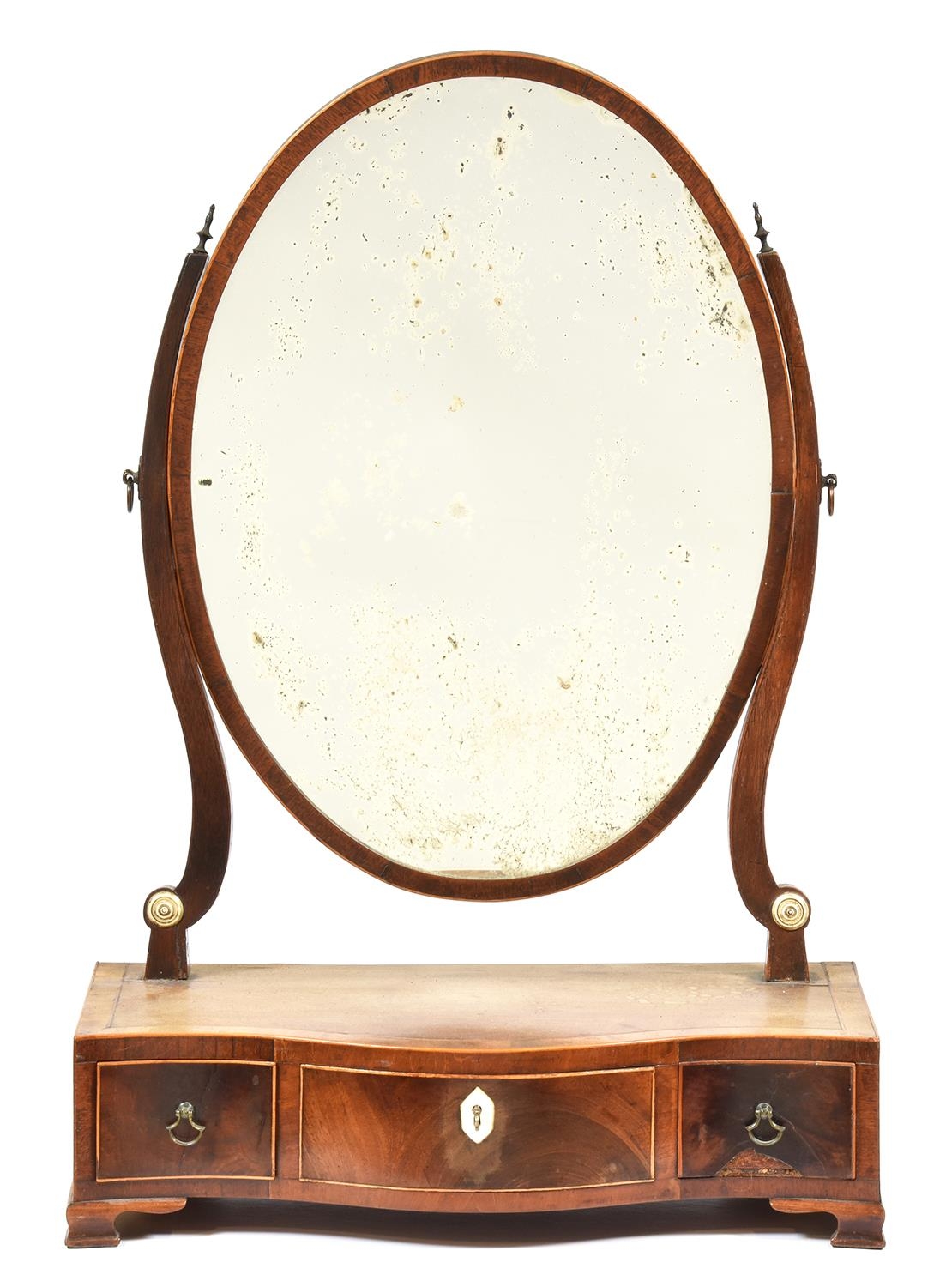 A George III mahogany dressing mirror late 18th c, the oval frame on crossbanded serpentine base,