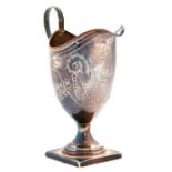 A George III helmet shaped silver cream jug, engraved with festoons, on square foot, crested, 14cm