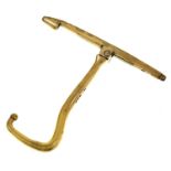 A George III silver gilt boot hook,  of T shape with pivoted angular handle, crested, 80mm h, by
