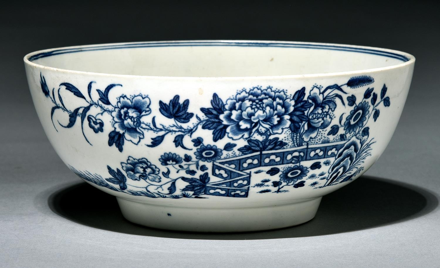 A Worcester bowl, c1780, transfer printed in underglaze blue with the Fence pattern, 20.5cm diam,