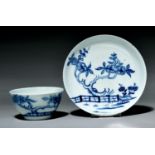 A Liverpool tea bowl and saucer, Richard Chaffers, c1760, painted in underglaze blue with a forked