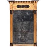 A Regency ebonised and giltwood pier mirror, early 19th century, with cleated pharaonic herm