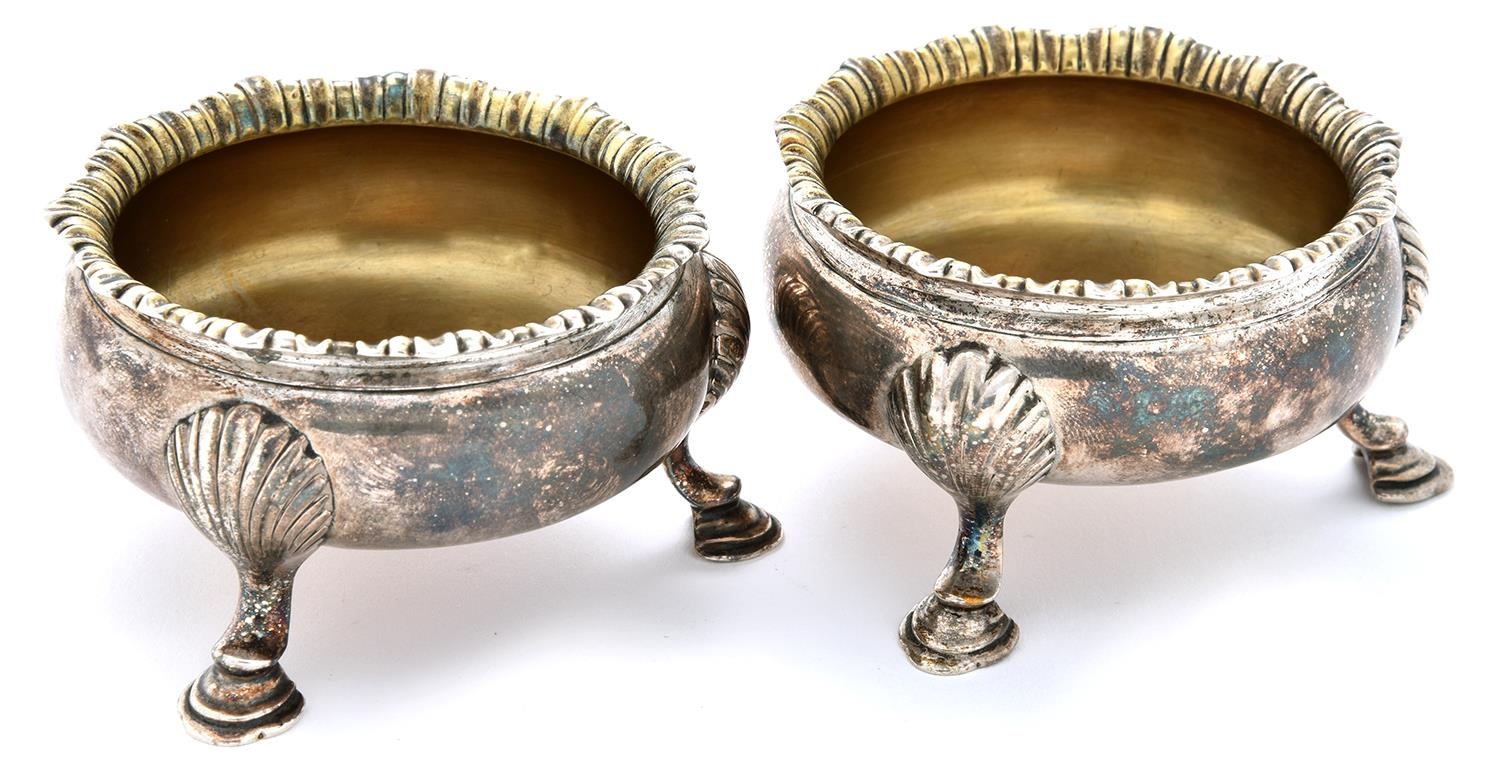 A pair of George II silver salt cellars, on three hoof feet, 70mm diam, by Fuller White, London