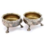 A pair of George II silver salt cellars, on three hoof feet, 70mm diam, by Fuller White, London