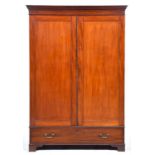 A Victorian mahogany wardrobe, mid 19th c, with dentil cornice and enclosed by a pair of panelled