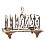 A George III silver toast rack, with seven crossed wire divisions, rectangular base and reeded feet,