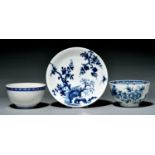 A Worcester saucer and two tea bowls, c1770, painted in underglaze blue with the Prunus Root,