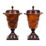 A pair of patinated metal urns and covers, 20th century, mottled light and dark brown patina, 35cm