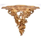 An Italian giltwood wall bracket, 20th c, in rococo style, 38cm h, shelf 25 x 49cm Gilding rubbed