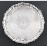A Victorian silver salver, engraved with rococo cartouche and initial S, the cavetto embossed with