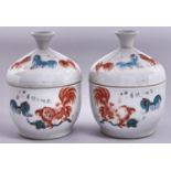 A pair of Chinese porcelain jars and covers, early 20th c, painted in iron red and green enamel with