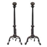 A pair of French iron firedogs, early 17th c, the slightly tapered chamfered pillar with square
