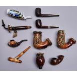 Smoking. Nine tobacco pipes, late 19th and early 20th c, the meerschaum examples including an