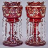 A pair of enamelled ruby glass lustres, late 19th c, hung with prismatic cut beads and pendants,