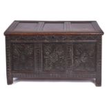 A Charles II oak chest, late 17th c, with three panel lid, those to the front carved at later