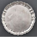 A George V silver waiter, 18cm diam, marks rubbed, Birmingham 1935, 6ozs 7dwts Worn and dented;