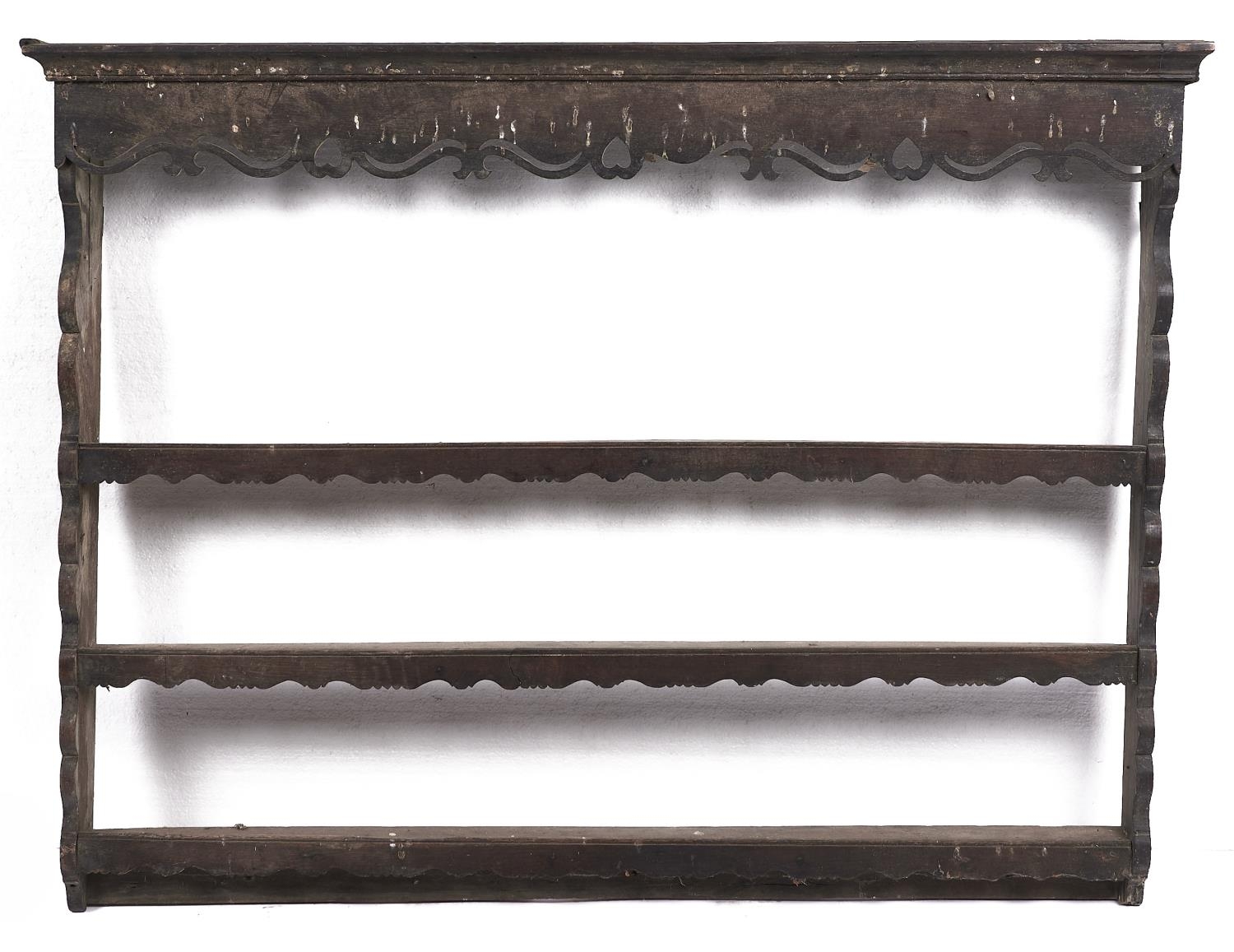 A George III oak plate rack, late 18th c, with cavetto cornice above pierced cresting centred by