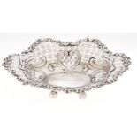 A Victorian pierced and die stamped silver sweetmeat basket, on ball feet, 20.5cm l, by J Millward