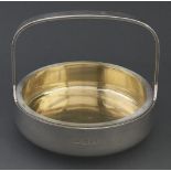 Robert Welch. A silver basket, the interior gilt, arched handle, glass liner, 12cm h, maker's