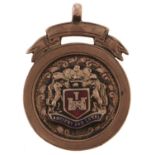 A 9ct gold and enamel watch fob shield, Birmingham 1925, 5.8g Worn