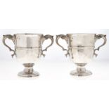 A pair of Irish George III silver two handled cups, c1770, with reeded girdle, on moulded foot, 14cm