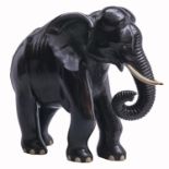 An Indian ebony carving of an elephant, early 20th c, with ivory tusks, 47cm h Broken and repaired