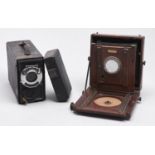 A folding mahogany and brass half plate camera, c1900 and an early 20th c Koilos camera (2) Both