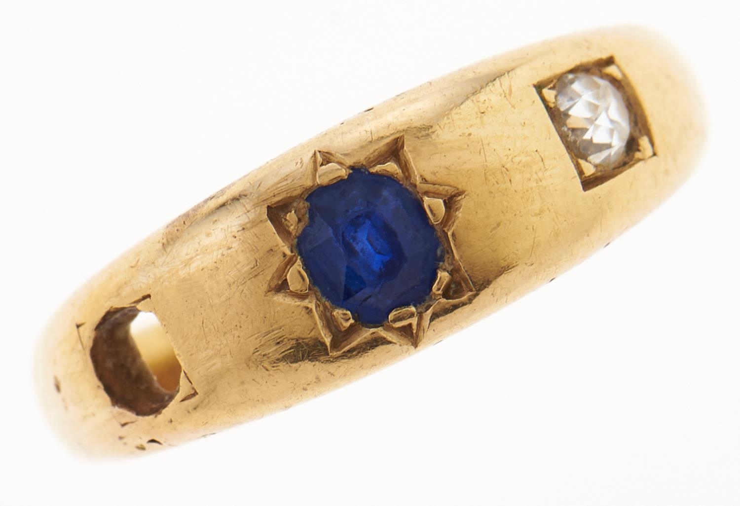 A sapphire and diamond ring, c1900, gipsy set, in gold, marked 18ct, 6.1g, size S One stone