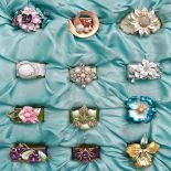 A set of twelve Thomas Goode giltmetal and enamel flower napkin rings, late 20th c, boxed Good