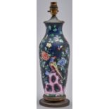 A Staffordshire black ground famille rose earthenware vase, mounted in brass as a table lamp, second