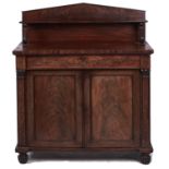 A Victorian mahogany chiffonier, with triangular upstand and shelf, enclosed by panelled doors,