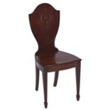 A George IV mahogany hall chair, second quarter 19th c, with shield shaped back, on square tapered