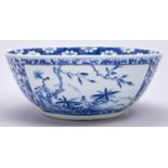 A Chinese blue and white punch bowl, 19th / 20th c, painted with panels of foliage on a ground of