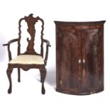 A George III bow fronted mahogany and crossbanded hanging corner cupboard, early 19th c, with