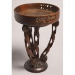 A carved and turned oak pedestal fruit bowl, first half 20th c, with acorn pierced gallery, on