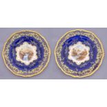 A pair of Coalport cobalt ground plates, c1914, painted by E O Ball or P Simpson, both signed,